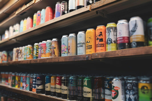 Variety of beer cans on a shelf. Which one has the least histamines? Feels overwhelming.