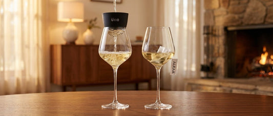Üllo wine purifier pouring wine beside an ALKAA sachet steeping in a wine glass